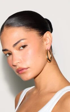 PrettyLittleThing Gold High-Shine Finish - Statement Rounded Oval Hoop Earrings 5 PrettyLittleThing Gold High-Shine Finish - Statement Rounded Oval Hoop Earrings -FRAME Clothing Shop 141522090debf0c58da62d06447138abe1398949 CMS2651 3 gold rounded oval hoop earrings