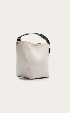 PrettyLittleThing Natural PU Buckle Strap Bucket Bag - Cream Shopper Tote -FRAME Clothing Shop 5b9fe085db3a1c808c5137777ce16ab3aaef0ebb CNN3448 3 natural canvas contrast handle tote back