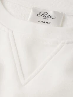 Ritz Paris Cream Tonal Logo & Crest – Luxe Cotton-Blend Crewneck Sweatshirt 21 Ritz Paris Cream Tonal Logo & Crest – Luxe Cotton-Blend Crewneck Sweatshirt -FRAME Clothing Shop MP25JSS006 CREA FABRIC DET2 sweatshirt texture detail image