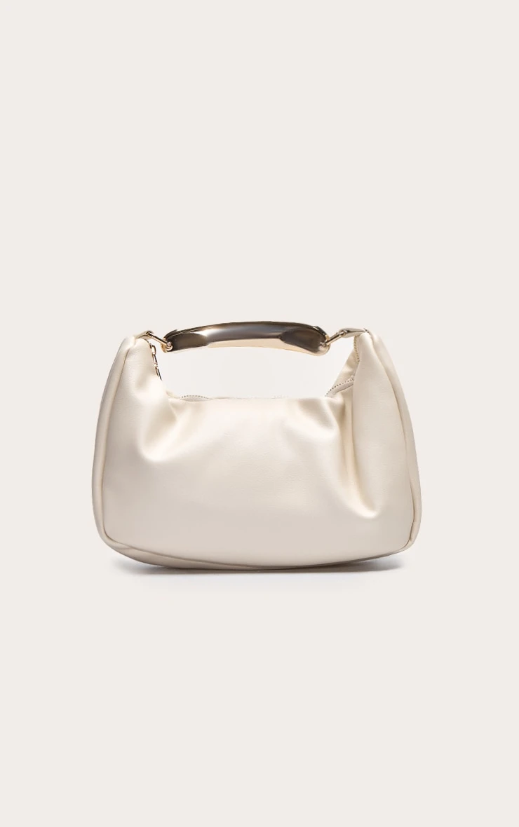 PrettyLittleThing Cream PU Gold Abstract Handle β Sculptural Mini Hand Bag 1 PrettyLittleThing Cream PU Gold Abstract Handle β Sculptural Mini Hand Bag